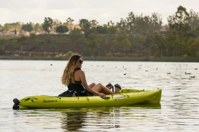 Slide: The Image of Woman kayaking on a lake in a 2024 Hobie Revolution 13 kayak. - 3