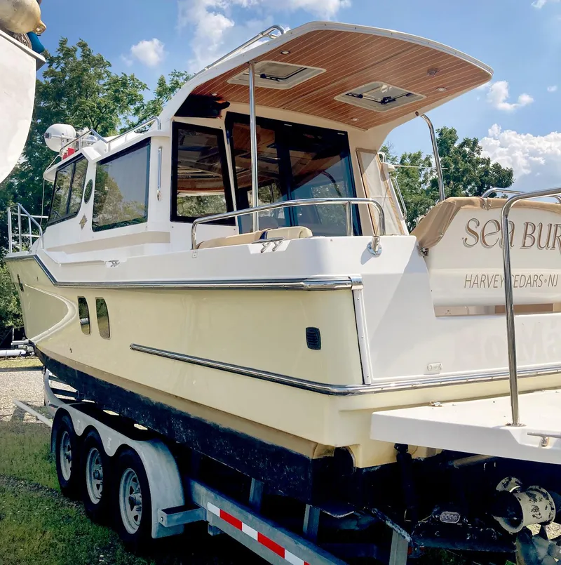Slide: The Image of 2018 Ranger Tugs R-29 S boat on trailer, outdoor setting, sunny day. - 2