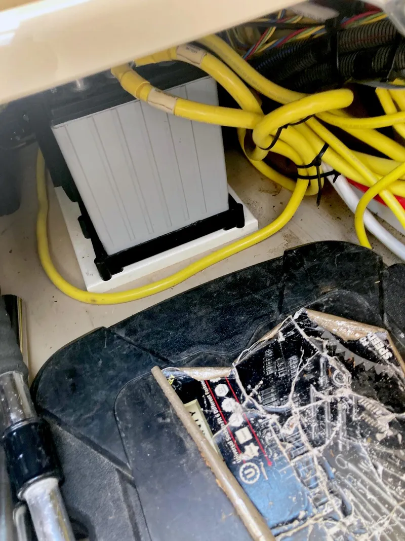 Slide: The Image of 2018 Ranger Tugs R-29 S engine compartment with battery and yellow cables. - 21