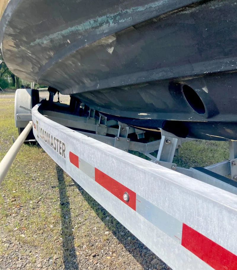 Slide: The Image of 2018 Ranger Tugs R-29 S boat on Loadmaster trailer, close-up view. - 24