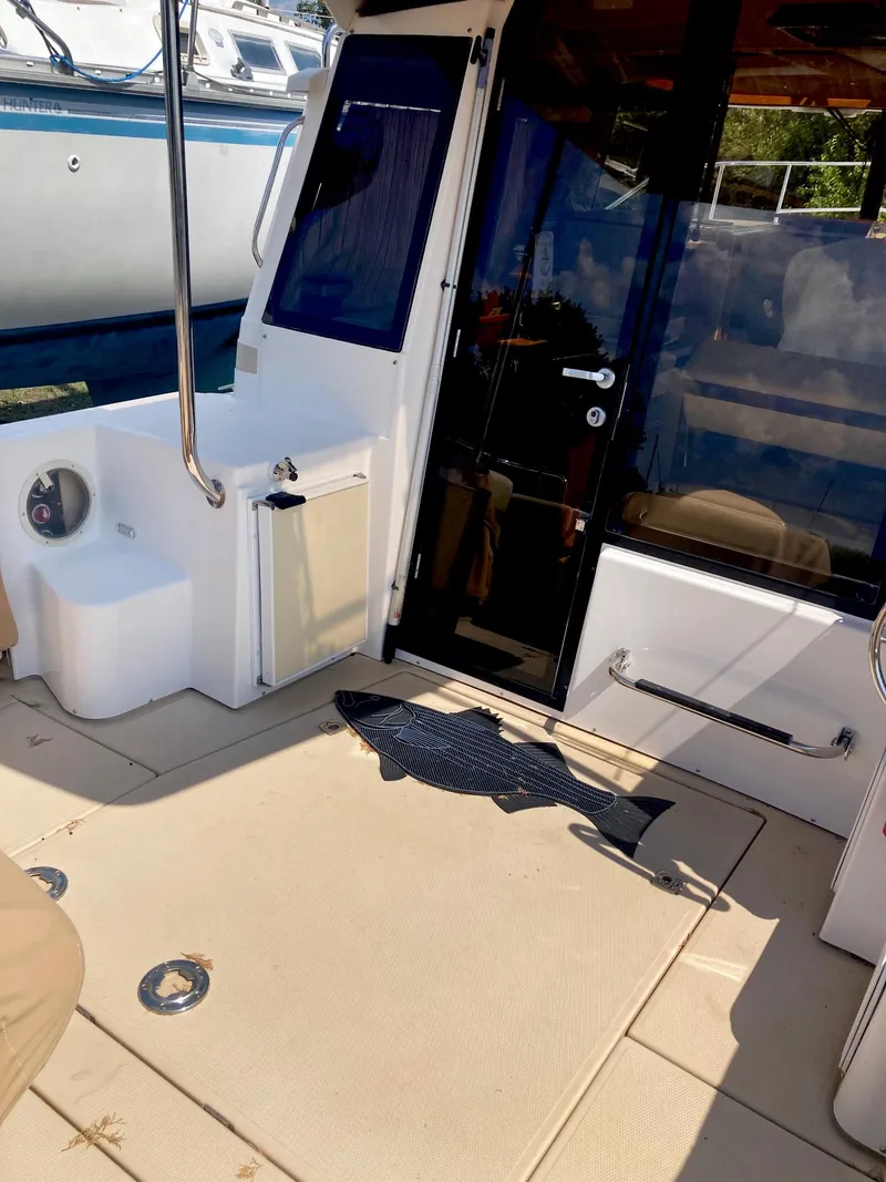 Slide: The Image of 2018 Ranger Tugs R-29 S boat deck with seating and door. - 5