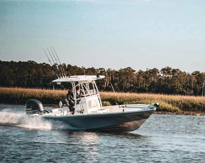 The Image of 2020 BlackJack 256 Bay boat cruising on a serene river with lush forest backdrop. - 0