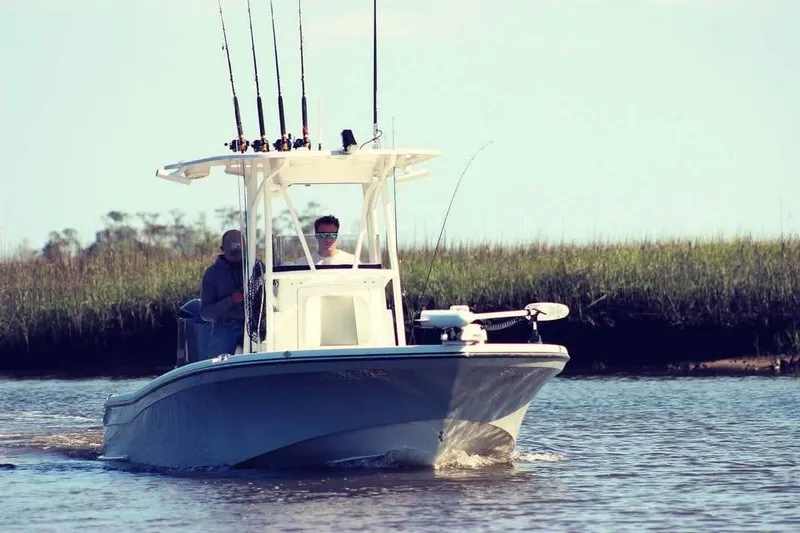 Slide: The Image of 2020 BlackJack 256 Bay boat cruising on a calm river with fishing rods. - 3