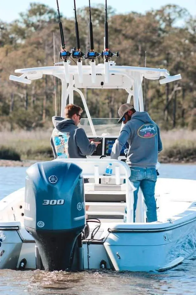 Slide: The Image of 2020 BlackJack 256 Bay boat with two people fishing, Yamaha 300 engine, scenic background. - 6