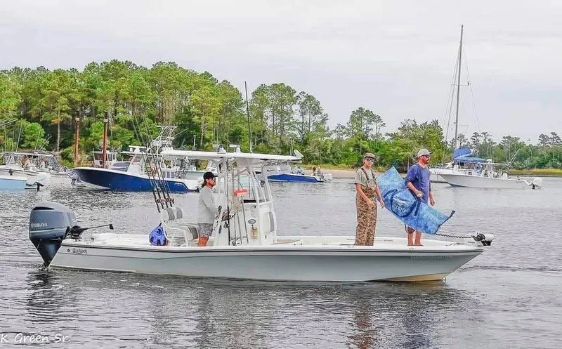Slide: The Image of 2020 BlackJack 256 Bay boat with people fishing on a calm lake. - 8