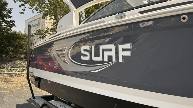 Slide: The Image of 2023 Chaparral 28 Surf boat with sleek design and bold "Surf" branding. - 1