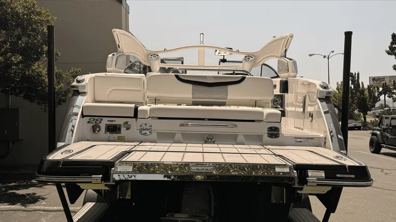 Slide: The Image of 2023 Chaparral 28 Surf boat rear view with open deck and seating. - 3