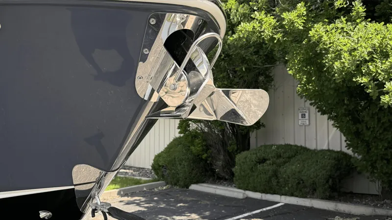 Slide: The Image of 2023 Chaparral 28 Surf boat propeller detail, parked outdoors. - 7