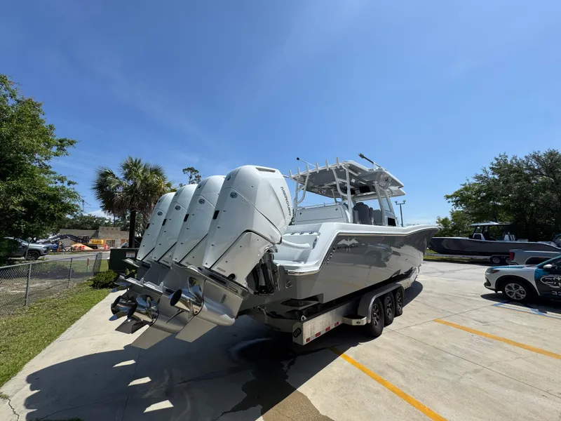 Slide: The Image of 2026 Invincible 43 Open Fisherman boat with quad engines in a sunny outdoor setting. - 10