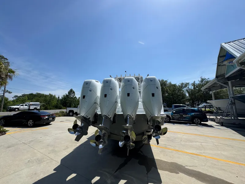 Slide: The Image of 2026 Invincible 43 Open Fisherman with four powerful outboard engines in a sunny marina. - 11