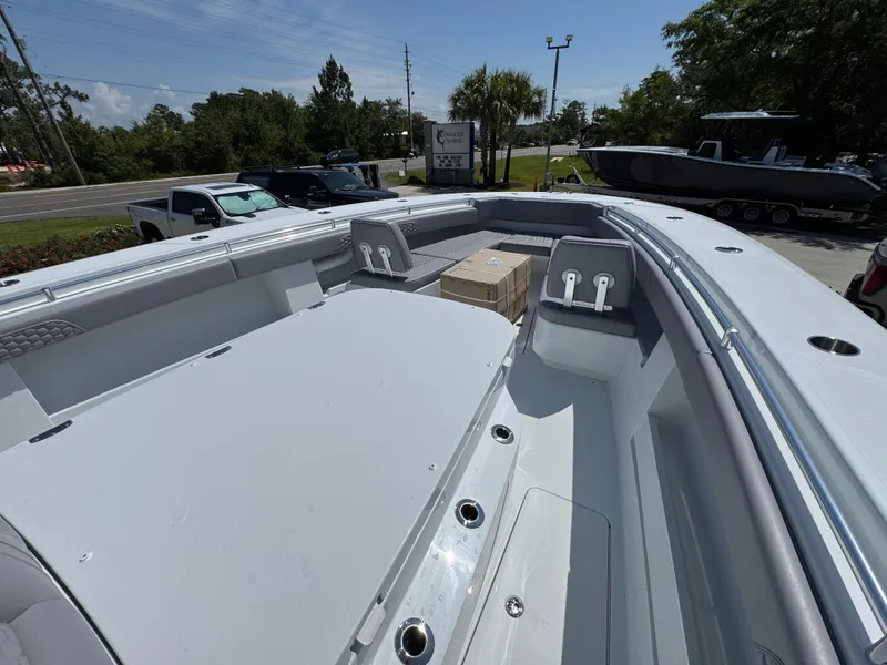 Slide: The Image of 2026 Invincible 43 Open Fisherman boat deck with seating and storage. - 15