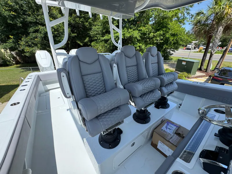 Slide: The Image of Luxurious seating on 2026 Invincible 43 Open Fisherman boat, featuring plush gray captain chairs. - 18