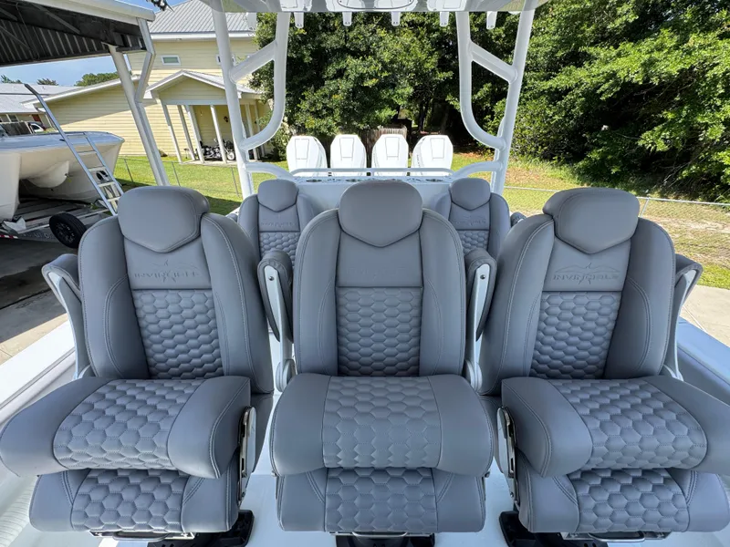 Slide: The Image of 2026 Invincible 43 Open Fisherman boat with luxurious gray seating, outdoor setting. - 19