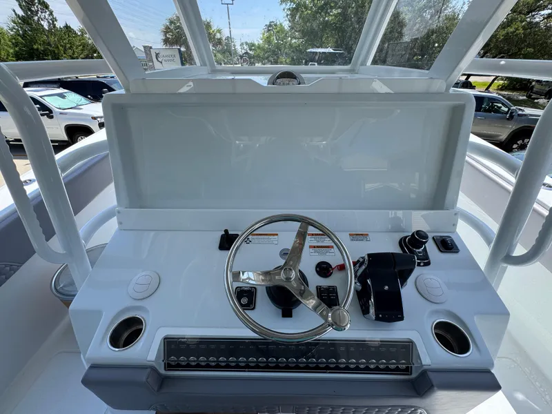 Slide: The Image of 2026 Invincible 43 Open Fisherman boat helm with steering wheel and controls. - 20