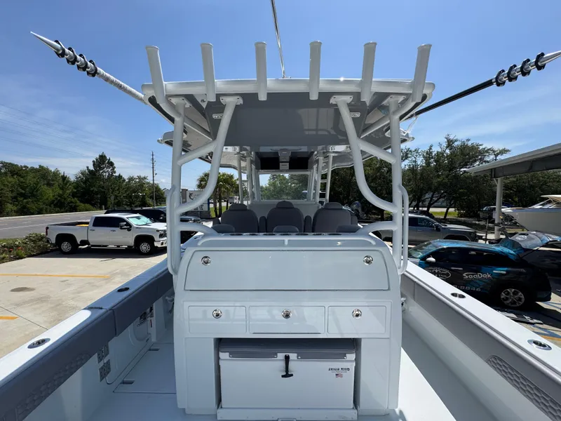 Slide: The Image of 2026 Invincible 43 Open Fisherman boat with center console and seating, parked outdoors. - 24