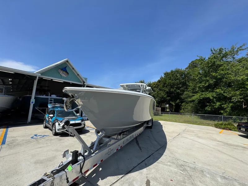 Slide: The Image of 2026 Invincible 43 Open Fisherman boat on trailer, parked outdoors under clear blue sky. - 4