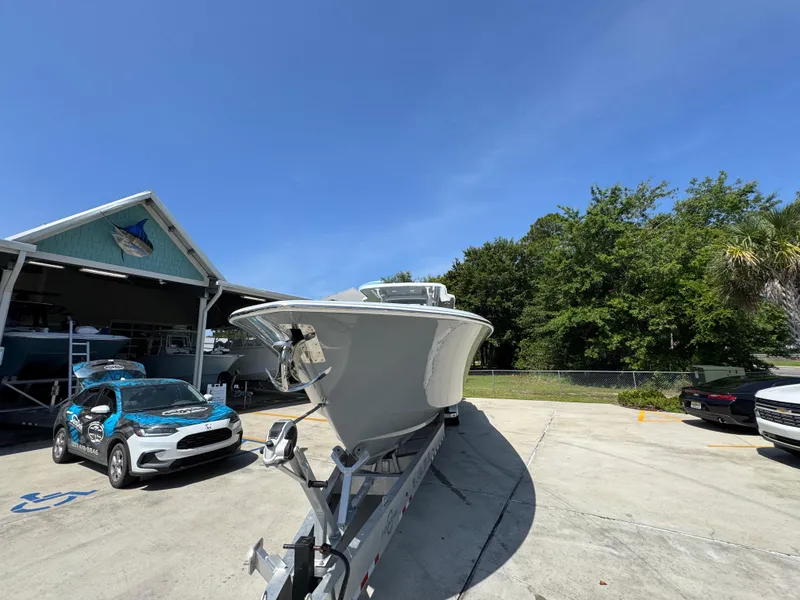 Slide: The Image of 2026 Invincible 43 Open Fisherman boat on trailer, parked outdoors under clear blue sky. - 5