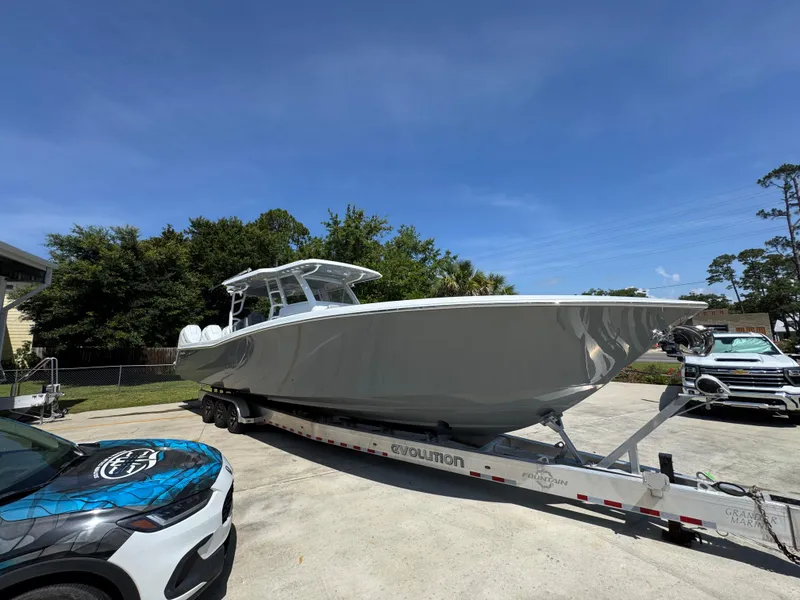 Slide: The Image of 2026 Invincible 43 Open Fisherman boat on trailer, parked outdoors under clear blue sky. - 7