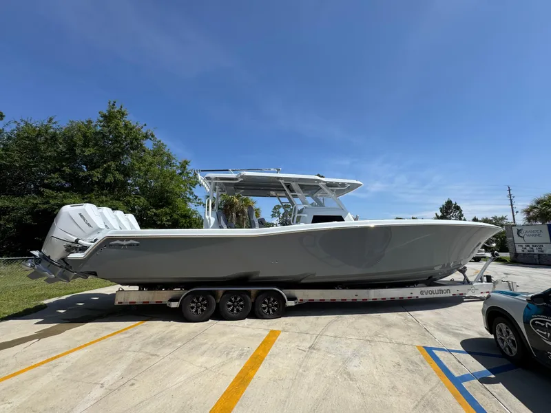 Slide: The Image of 2026 Invincible 43 Open Fisherman boat on trailer under clear blue sky. - 8