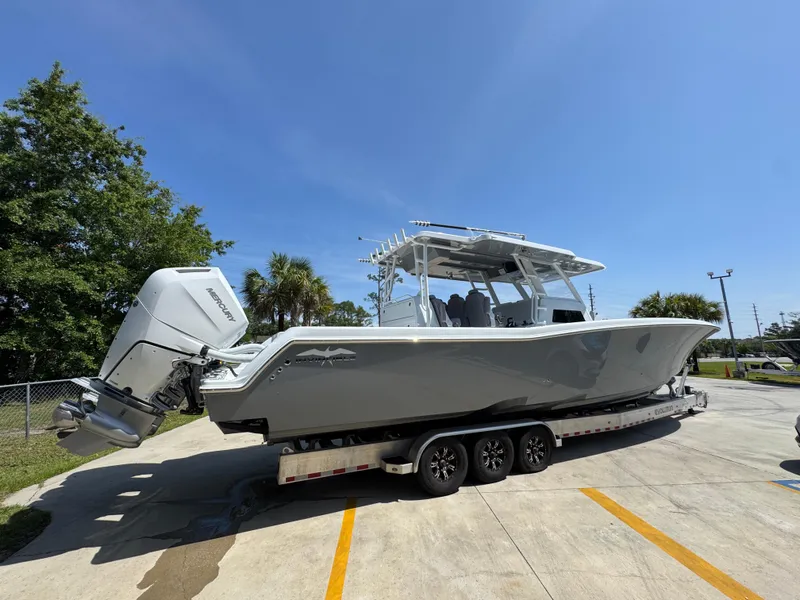 Slide: The Image of 2026 Invincible 43 Open Fisherman boat on trailer, parked outdoors under clear sky. - 9