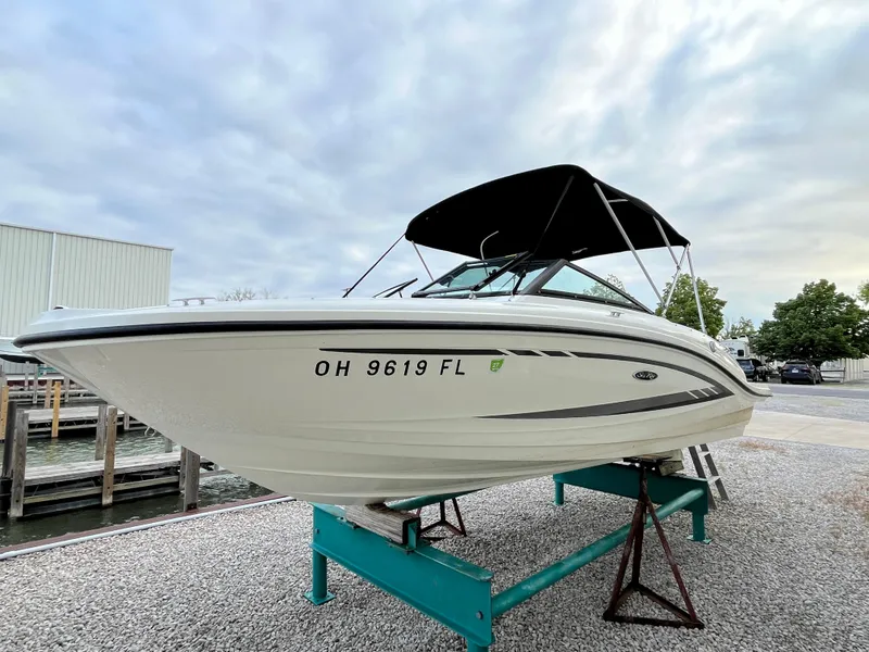 The Image of 2015 Sea Ray 19 SPX boat on display with black canopy and registration number. - 0