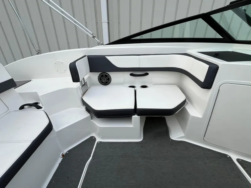 Slide: The Image of 2015 Sea Ray 19 SPX boat interior with white and black seating, speaker, and carpeted floor. - 10