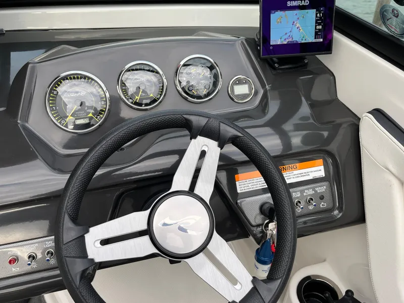 Slide: The Image of Steering wheel and dashboard of 2015 Sea Ray 19 SPX boat with navigation display. - 14