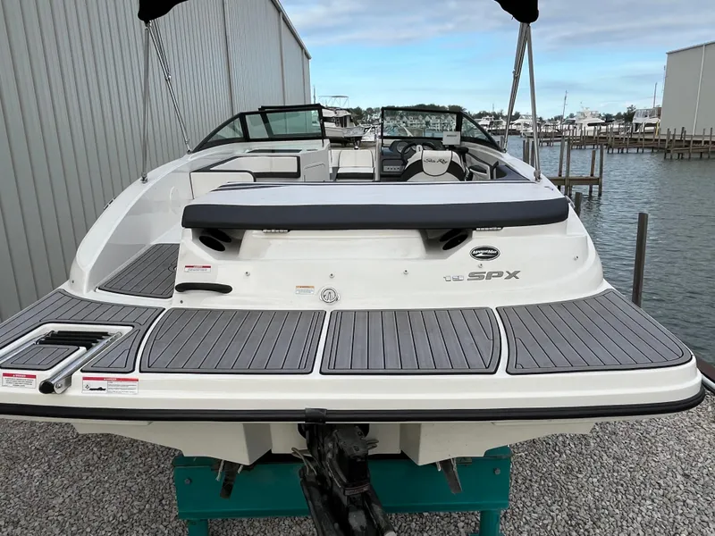 Slide: The Image of 2015 Sea Ray 19 SPX boat docked near marina, rear view. - 7