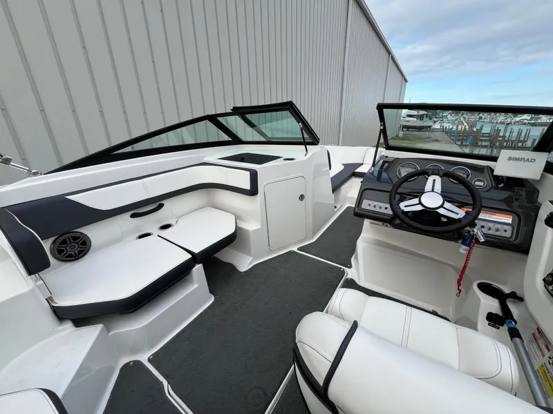 Slide: The Image of 2015 Sea Ray 19 SPX boat interior with modern seating and steering console. - 9