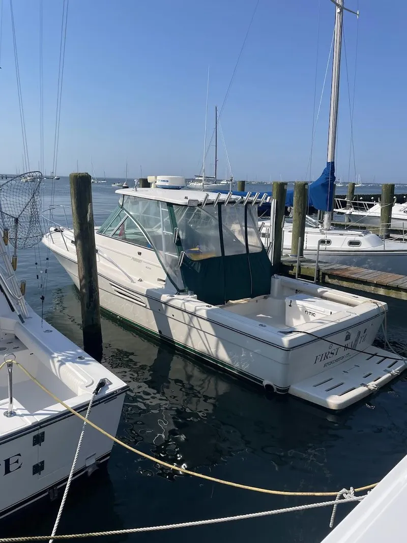 The Image of 2000 Pursuit 3000 Express boat docked at marina on a sunny day. - 0