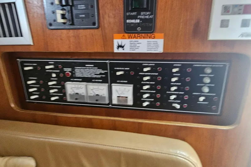 Slide: The Image of Control panel of a 2000 Pursuit 3000 Express boat, featuring various switches and gauges. - 13