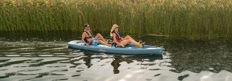 Slide: The Image of Two people kayaking on a 2025 Hobie Compass Duo in a serene waterway. - 4