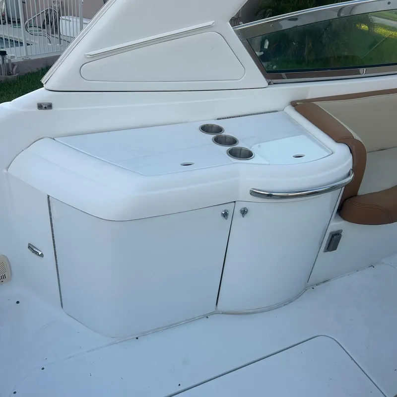 Slide: The Image of 2005 Formula 330 SS boat interior with white cabinetry and cup holders. - 10
