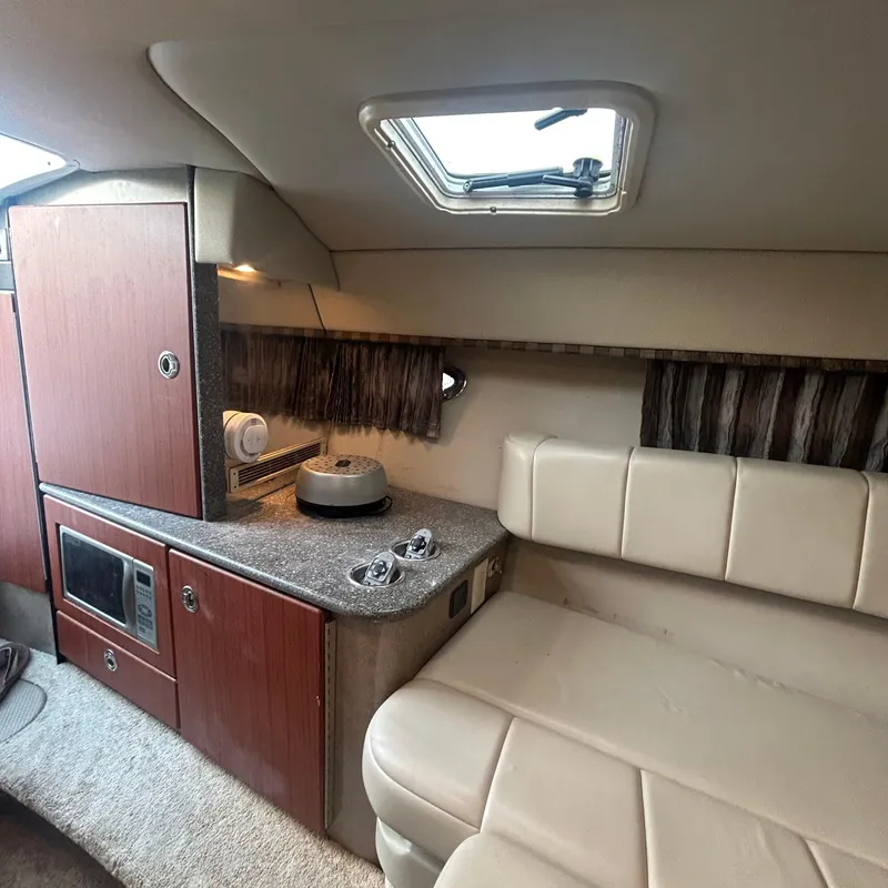 Slide: The Image of Interior of a 2005 Formula 330 SS boat with kitchenette and seating area. - 12