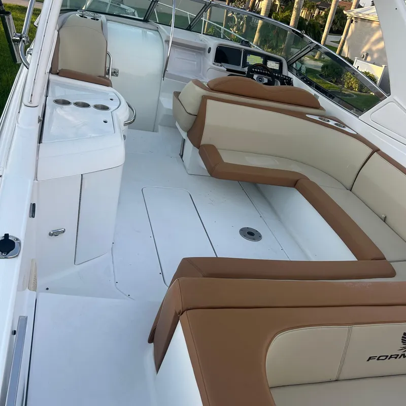 Slide: The Image of 2005 Formula 330 SS boat interior with beige seating and helm. - 16