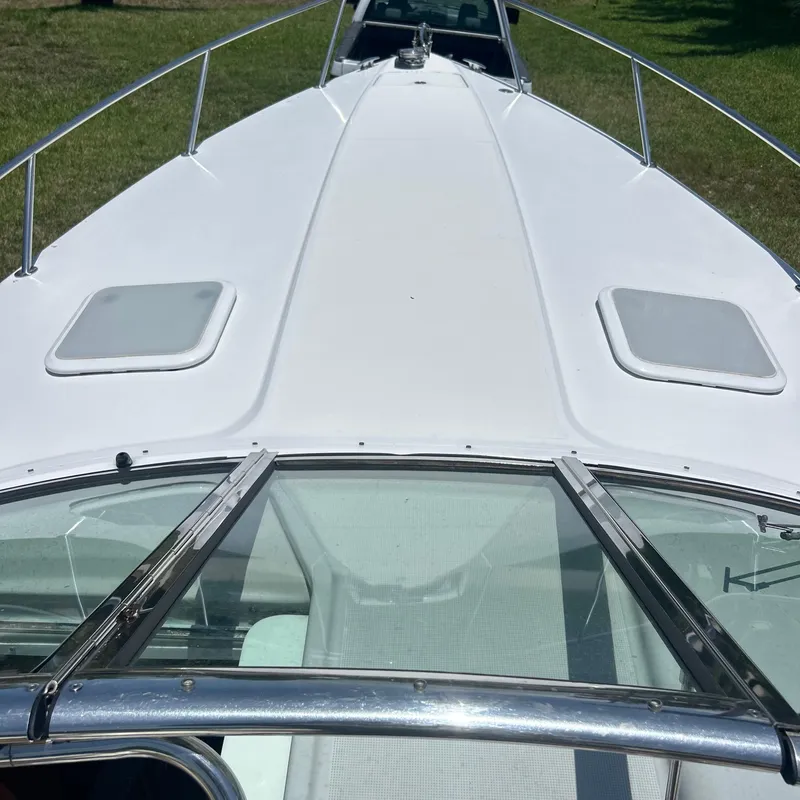 Slide: The Image of 2005 Formula 330 SS boat deck with sleek design and dual hatches. - 5