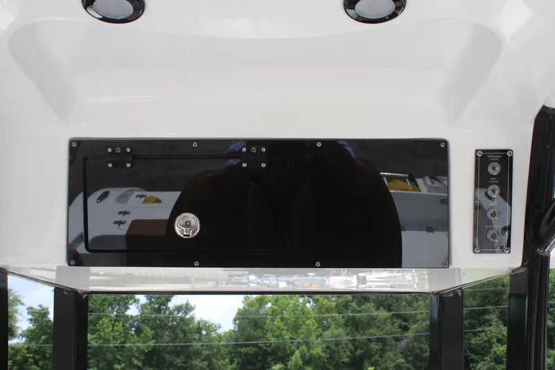 Slide: The Image of 2024 Sea Pro 242 Center Console dashboard with control panel and storage compartment. - 13