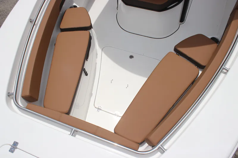 Slide: The Image of 2024 Sea Pro 242 Center Console boat interior with tan cushioned seating. - 14