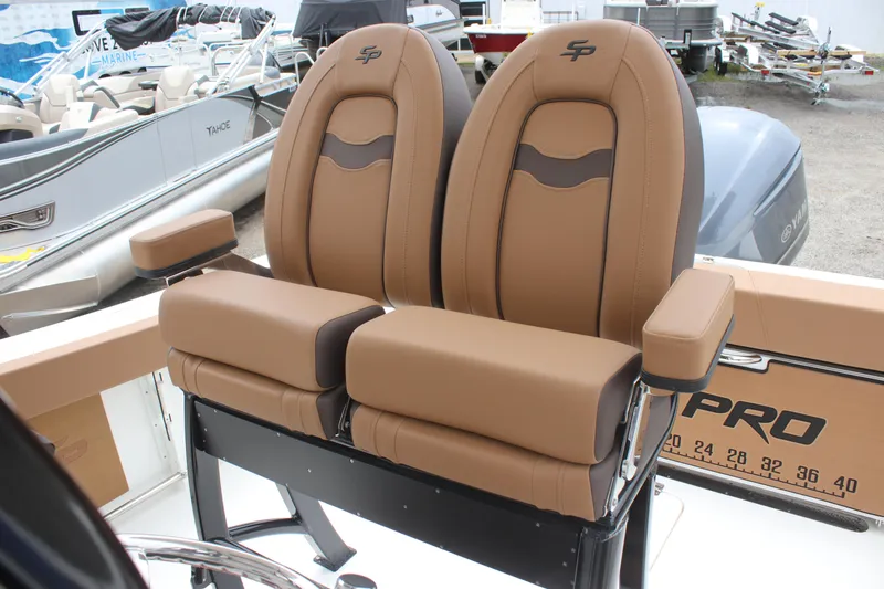 Slide: The Image of 2024 Sea Pro 242 Center Console boat seats, featuring tan upholstery and armrests. - 15