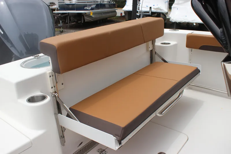 Slide: The Image of 2024 Sea Pro 242 Center Console boat with brown cushioned seating. - 17