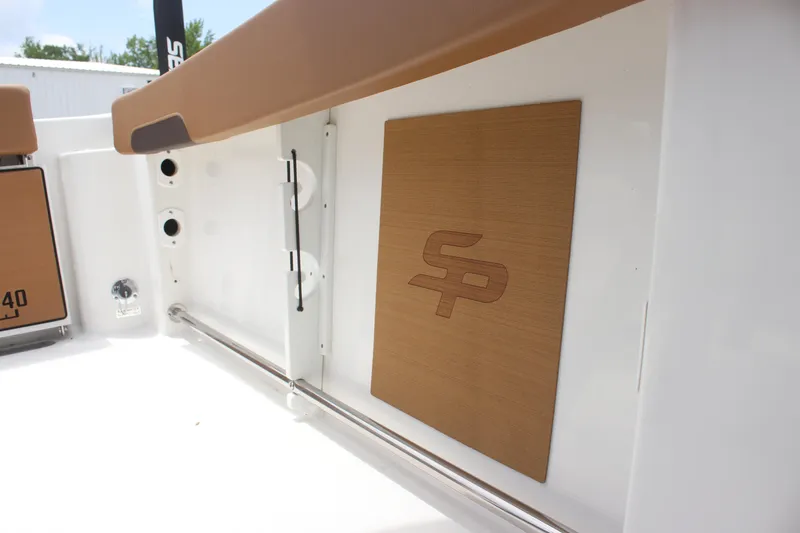 Slide: The Image of 2024 Sea Pro 242 Center Console interior detail with logo and storage features. - 19