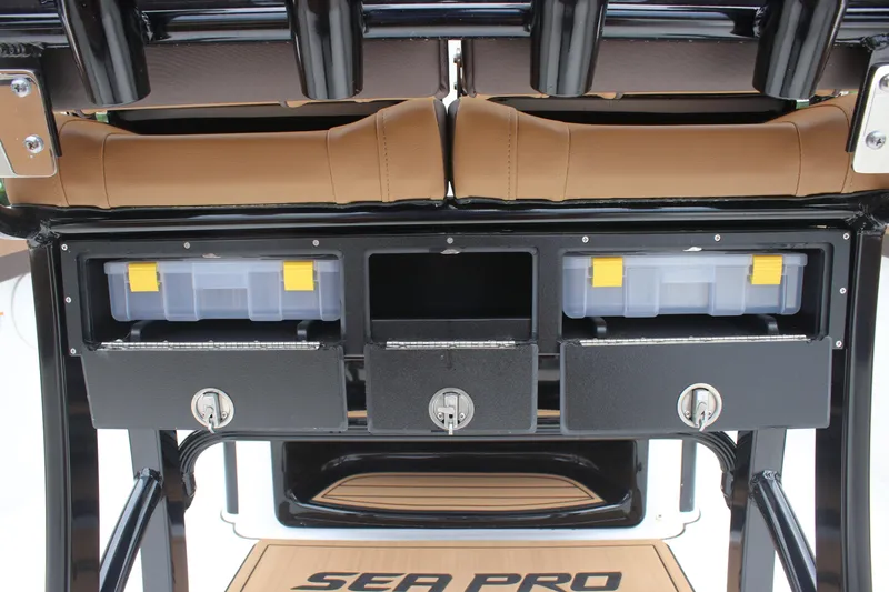 Slide: The Image of 2024 Sea Pro 242 Center Console storage area with tackle boxes and seating. - 24