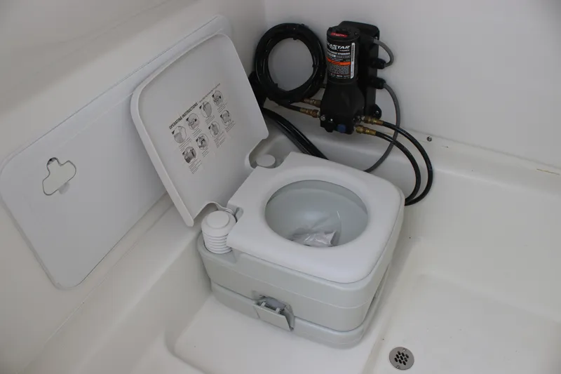 Slide: The Image of 2024 Sea Pro 242 Center Console boat with portable marine toilet in the cabin. - 30