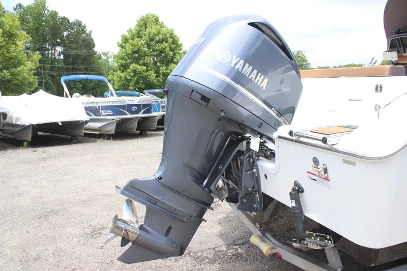 Slide: The Image of 2024 Sea Pro 242 Center Console with Yamaha outboard motor in a boatyard. - 31