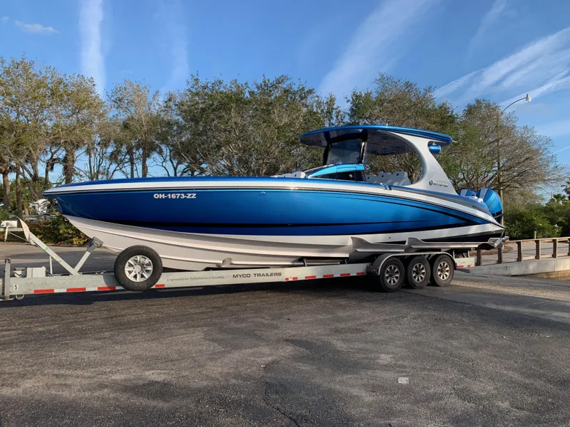 The Image of 2023 Mystic Powerboats M3800 in blue on a trailer, parked outdoors. - 1