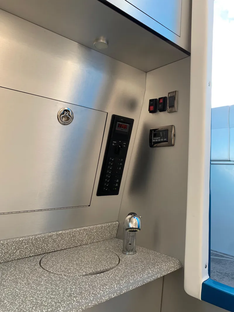 Slide: The Image of 2023 Mystic Powerboats M3800 interior with control panel and modern fixtures. - 11