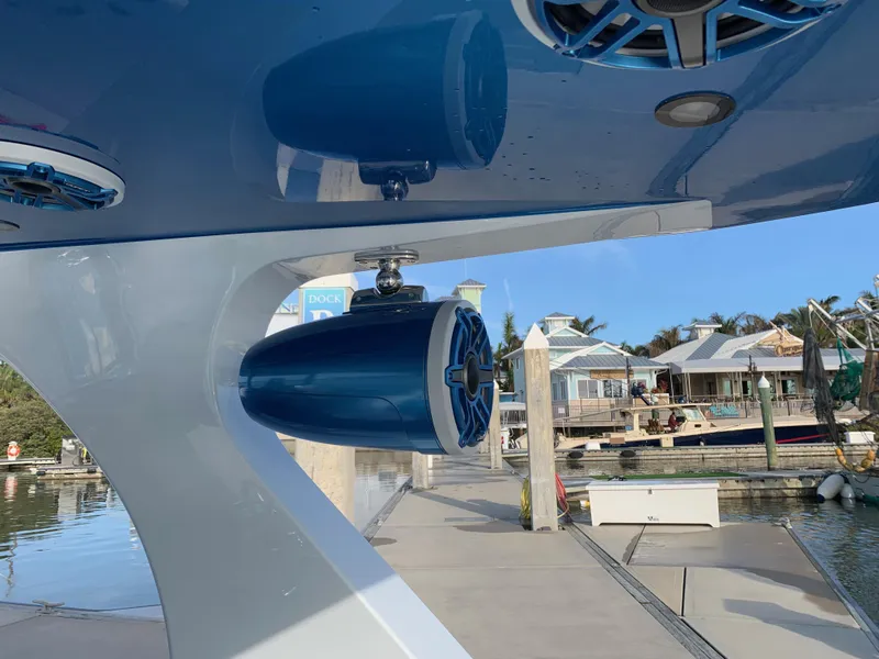 Slide: The Image of 2023 Mystic Powerboats M3800 speaker system at a marina dock. - 15