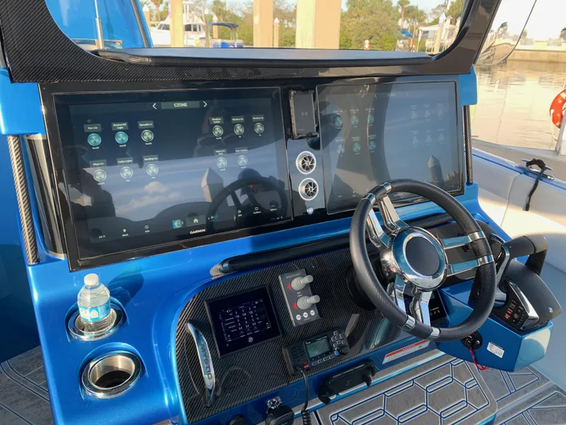 Slide: The Image of 2023 Mystic Powerboats M3800 dashboard with advanced controls and dual screens. - 5