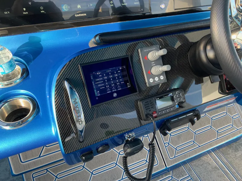 Slide: The Image of Control panel of 2023 Mystic Powerboats M3800 with advanced navigation and communication systems. - 6