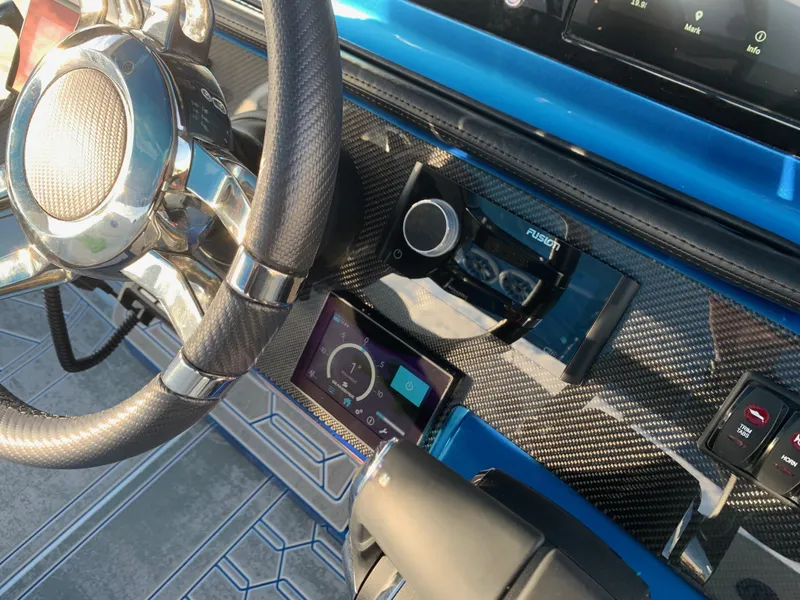 Slide: The Image of Dashboard of 2023 Mystic Powerboats M3800 with carbon fiber finish and modern controls. - 7